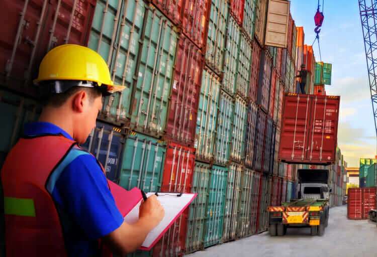 Top 8 Tips On Importing Products From China 3 A picture of a person preparing to ship a package, with boxes and shipping materials in the background. This could represent the importance of properly planning and preparing for the shipping and customs process when importing from China.